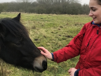 Residential volunteer Sophie Lane and a Highland pony