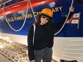 Marine intern Mona stood in front of a lifeboat