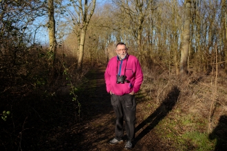 Vic stands in a woodland