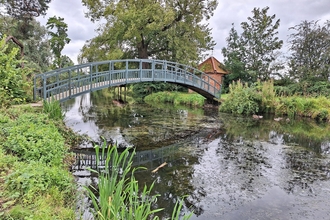 Humpback bridge over a lake at Doddington Hall