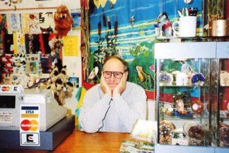 Brian Tear sitting behind the counter in the Wildlife Gift Shop in Lincoln
