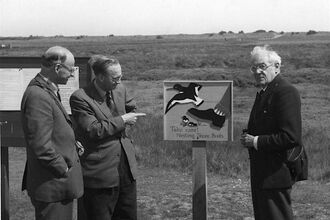 Ted Smith with nesting shorebirds sign Gib black and white
