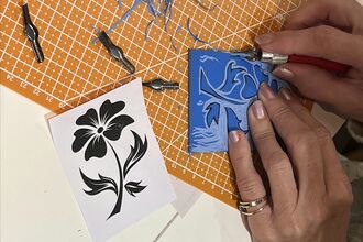 hands doing lino print