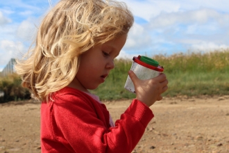 Girl looking for wildlife on the beach