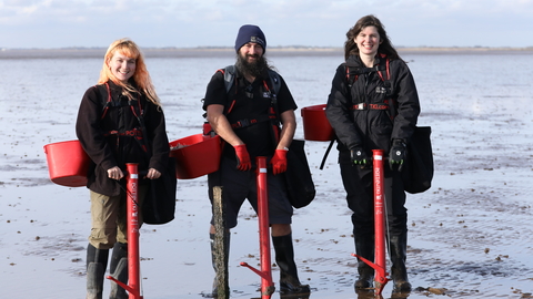 Three people planting seagrass (c)Cate Holburn
