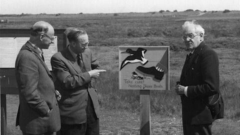 Ted Smith with nesting shorebirds sign Gib black and white