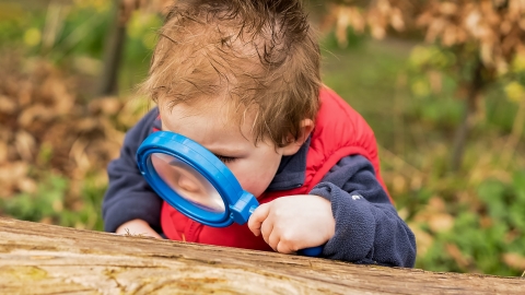Boy with magnifying glass