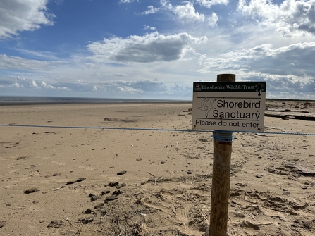 Sign and fenceline of the Shorebird Sanctuary at Gibraltar Point