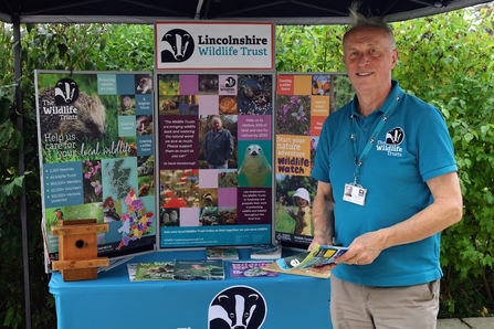 Man standing by a Lincolnshire Wildlife Trust information stand