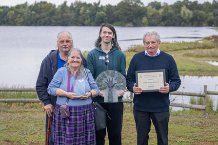 Four volunteers from Sutton-on-Sea Beachcare holding the Lincolnshire Environmental award