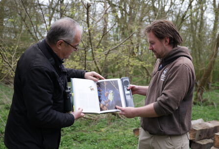 Rich and Melvyn looking at a bird identifying book