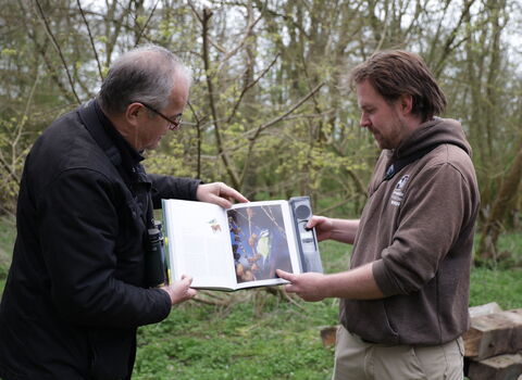 Rich and Melvyn looking at a bird identifying book